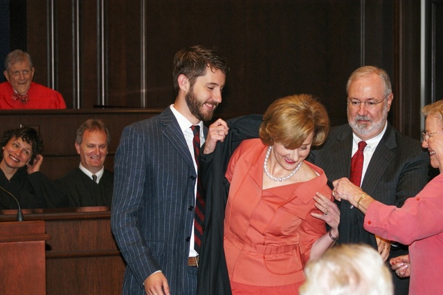 Erny "Beth" Foote gets help from family in putting on her robe as newest Federal Court Judge for Western District of Louisiana 9-10-10