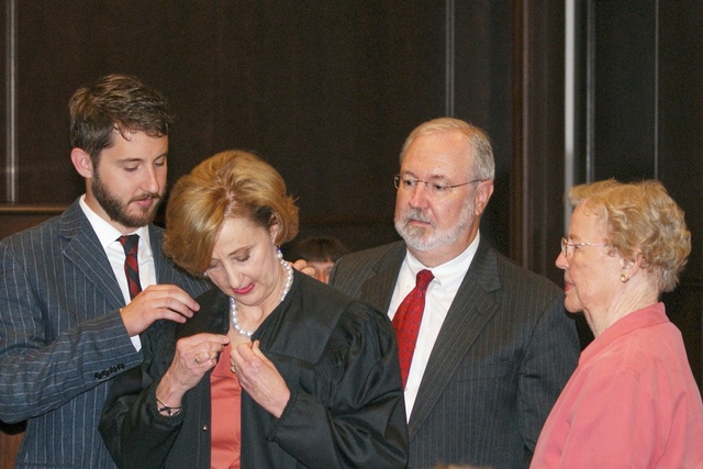 Judge Erny "Beth" Foote buttons robe after Swearing-In at Federal Courthouse in Shreveport, La. 9-10-10