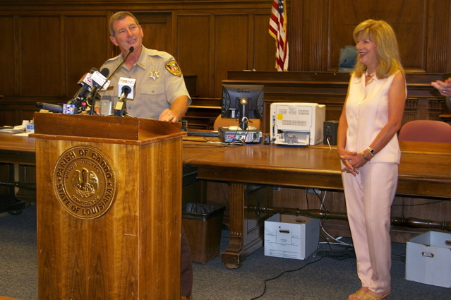 Caddo Sheriff Steve Prator speaks to his deputies and audience after being sworn-in June 30th, 2008, for his third four-year term...while Prator's wife Carolyn, watches.